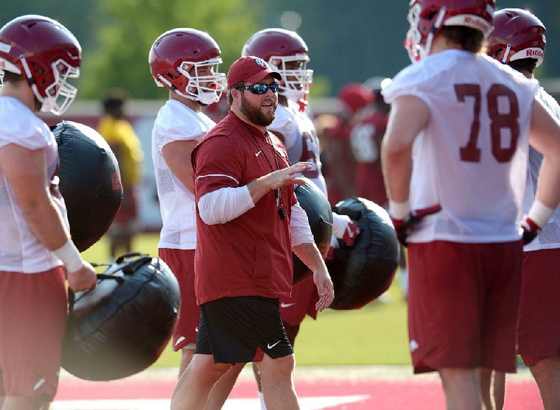 NWA Democrat-Gazette/ANDY SHUPE
Arkansas offensive line coach Dustin Fry speaks to his players Friday, Aug. 3, 2018, during practice at the university practice field on campus in Fayetteville. Visit nwadg.com/photos to see more photographs from the practice.