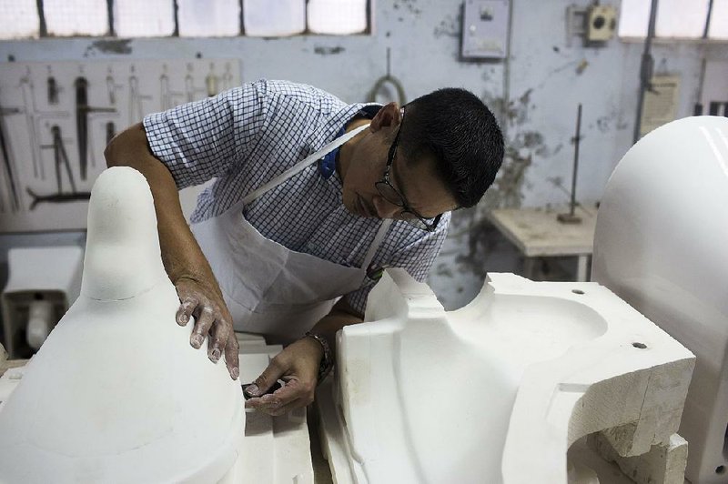 An employee works on a mold at the HSIL Ltd. factory in Haryana, India. India’s toilet-building mission has been a boon for some manufacturers.