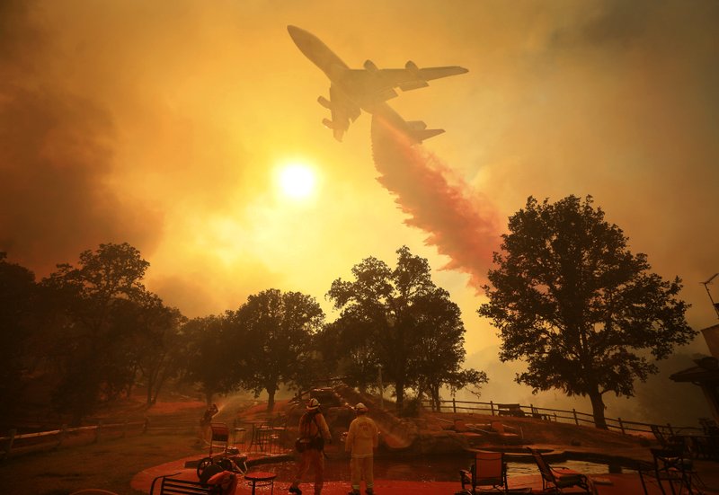 A 747 Global Airtanker makes a drop in front of advancing flames from a wildfire Thursday, Aug. 2, 2018, in Lakeport, Calif. (Kent Porter /The Press Democrat via AP)