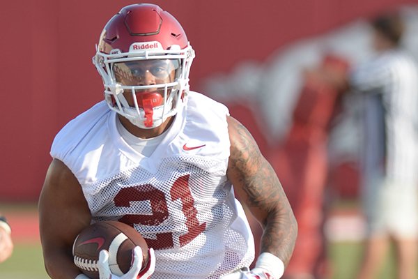 Arkansas running back Devwah Whaley carries the ball Friday, Aug. 3, 2018, during practice at the university practice field on campus in Fayetteville.