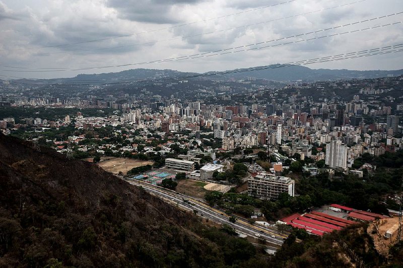 Caracas, Venezuela, is seen from cable cars over the Waraira Repano National Park. Venezuelans are increasingly being separated into two classes, those who have dollars and those who do not.