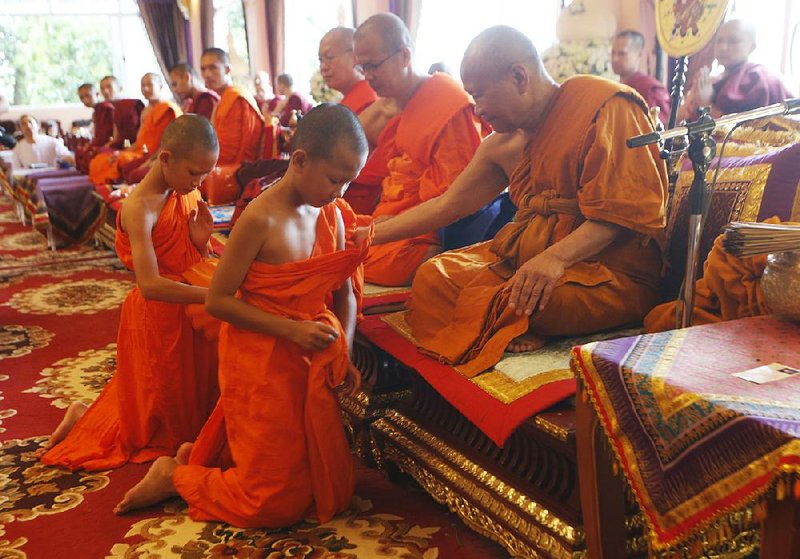 Boys rescued from a cave in northern Thailand last month attend a ceremony Saturday marking the completion of their time as novice Buddhist monks.