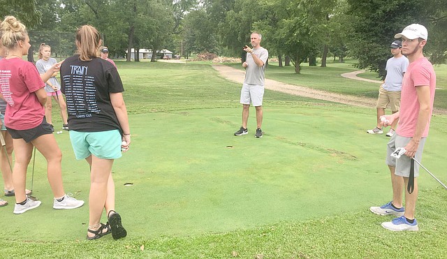 Graham Thomas/Herald-Leader Members of the Siloam Springs girls and boys golf teams listen as golf head coach Michael Robertson gives instructions prior to practice on July 26. The Panthers and Lady Panthers are set to open the season Monday and Tuesday at the Ultimate Auto Group High School Invitational at Big Creek Golf and Country Club in Mountain Home.