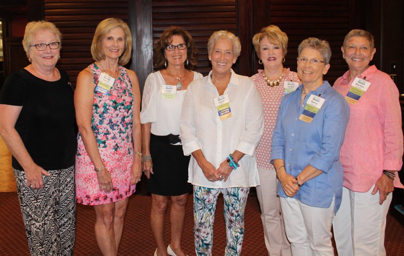 NWA Democrat-Gazette/CARIN SCHOPPMEYER Sharon Young (from left), Carol Adams, Linda Hankins, Sarah Kendall, Jackie Broshears, Nancy Swearingen and Marilyn Swearingen, Circle of Life Auxiliary founding members, welcome guests to the group's annual Impact Luncheon on July 24 at Pinnacle Country Club.