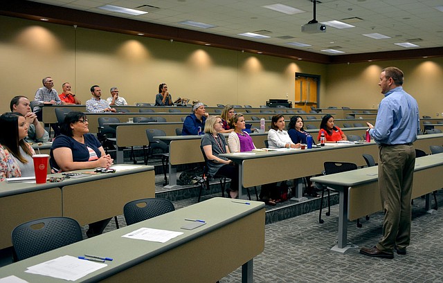 Hunter McFerrin/Siloam Sunday High school assistant principal Ross White led Wednesday's meeting, and among other things, explained to educators and industry representatives what the high school's ultimate goal is for their Career and Technical Education students.