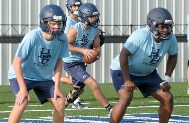 Springdale Har-Ber’s Max Pena (center) runs through drills Tuesday during football practice at Wildcat Stadium in Springdale. Har-Ber welcomed more than 150 players into camp this week as the Wildcats began preparations for the Aug. 24 season-opener against Pulaski Academy.