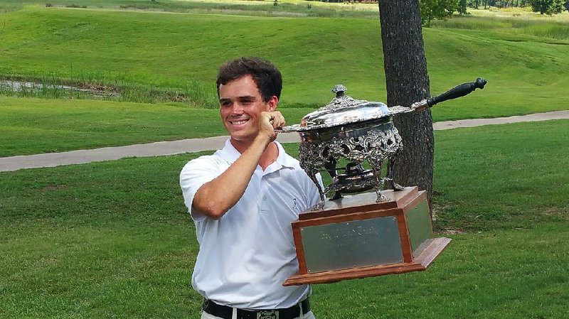 Little Rock’s Miles Smith displays his trophy after defeating Luke Cornett of Drasco 3-and-2 in the final of the 52nd annual Arkansas State Golf Association Men’s Match Play Championship on Sunday morning at Harbor Oaks Golf Club.