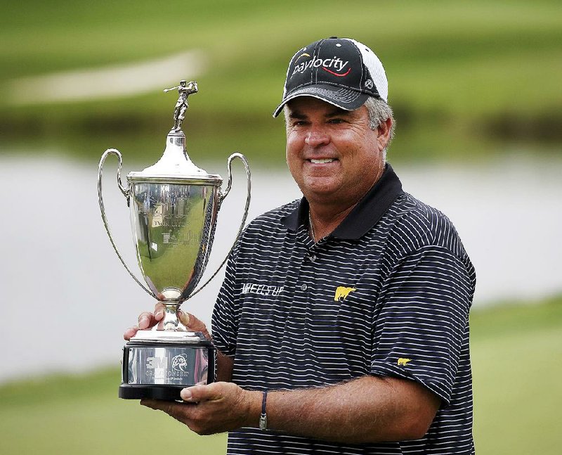 Kenny Perry holds the trophy Sunday after winning the 3M Championship golf tournament at TPC Twin Cities in Blaine, Minn.