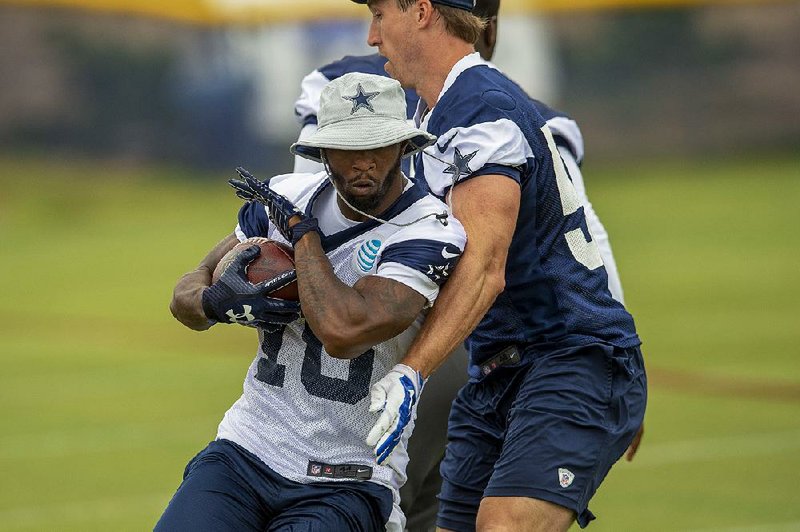 Dallas Cowboys running back Tavon Austin (left) runs by linebacker Sean Lee during training camp July 26 in Oxnard, Calif. Plagued by injuries with the Los Angeles Rams, Austin, the eighth overall pick in the 2013 draft, is healthy as he seeks a fresh start with the Cowboys.