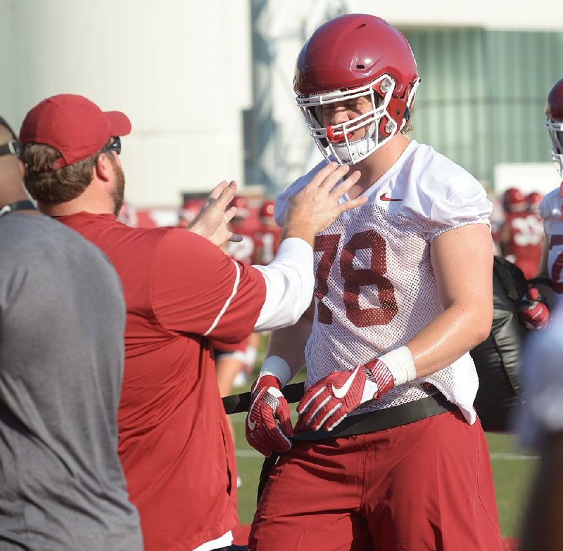 NWA Democrat-Gazette/ANDY SHUPE
Arkansas offensive lineman Dalton Wagner (78) speaks with position coach Dustin Fry as he participates in a drill Friday, Aug. 3, 2018, during practice at the university practice field on campus in Fayetteville. Visit nwadg.com/photos to see more photographs from the practice.