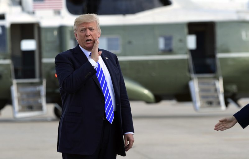 FILE - In this Sept. 26, 2017, file photo, President Donald Trump responds to a reporter's question on health care after arriving at John F. Kennedy International Airport in New York. Trump says insurers are &#x201c;going wild&#x201d; about his new health care options and &#x201c;millions and millions&#x201d; of people will be signing up. But insurance companies say it will take time to design new plans and get approval from state regulators, and two major industry groups have actually expressed concern about potential downsides for consumers.(AP Photo/Susan Walsh, File)