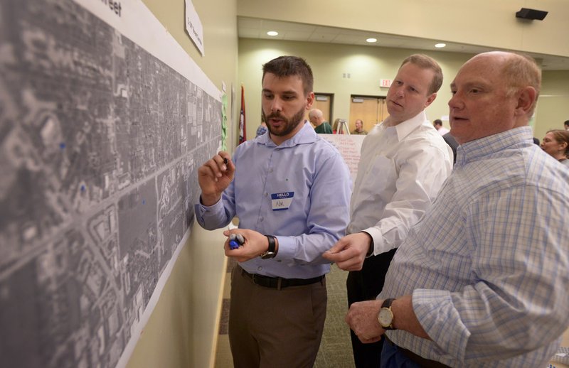 File Photo/NWA Democrat-Gazette/BEN GOFF &#8226; @NWABENGOFF Nik Davis (from left) with Houseal Lavigne Associates marks a map as James Smith, Bentonville councilman, and Jim Grider with the Bentonville Planning Commission share their thoughts during a February 2016 workshop hosted by Houseal Lavigne Associates at the Bentonville Public Library about the Bentonville Community Plan.