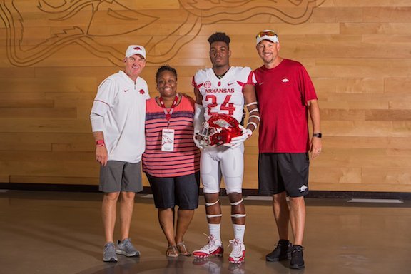 From left, Arkansas coach Chad Morris, Lateisha Floyd, A'Montae Spivey and Arkansas running backs coach Jeff Traylor.