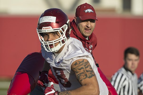 JEREMY PATTON goes through a drill with Barry Lunney Jr., Arkansas tight ends coach, on March 1 during spring football practice at the Fred W. Smith Football Center in Fayetteville.

