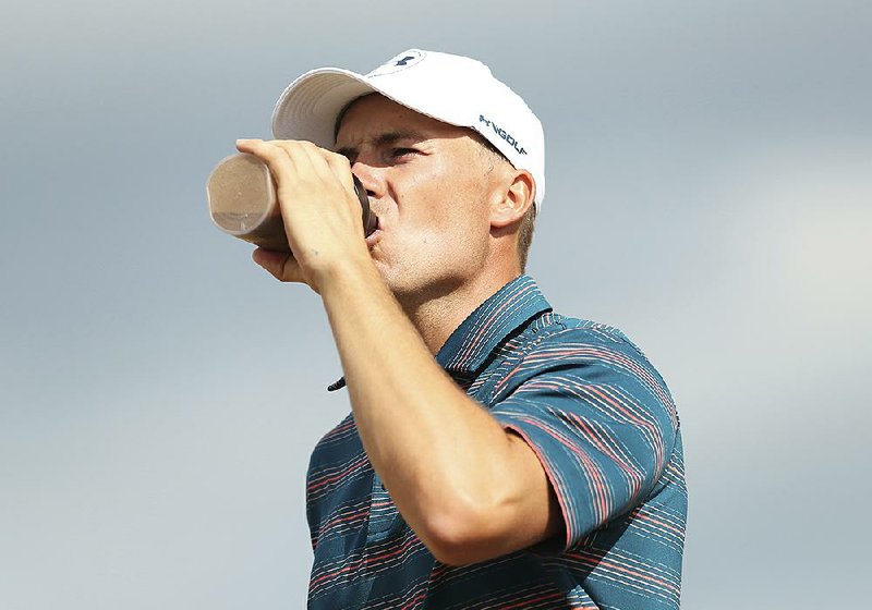 Jordan Spieth takes a drink as he walks off the ninth tee box during the final round of the British Open on July 22 in Carnoustie, Scot- land. Spieth and his fellow golfers may need plenty of liquids on hand as they compete in the August heat at this week’s PGA Championship in St. Louis.