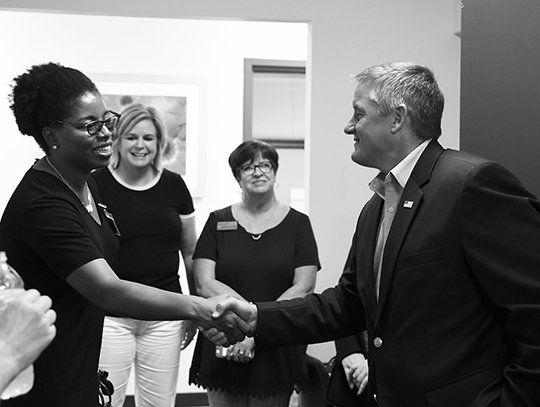 The Sentinel-Record/Grace Brown CONGRESSIONAL VISIT: U.S. Rep. Bruce Westerman, R-District 4, left, shakes hands with Lyniya Johnson, an investigator with the Arkansas State Police Crimes Against Children division, while touring the Cooper-Anthony Mercy Child Advocacy Center on Monday. Westerman earlier attended a Coffee with a Congressman event at The Greater Hot Springs Chamber of Commerce.