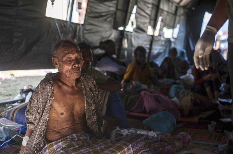The Associated Press EARTHQUAKE SURVIVOR: An elderly man rests in a makeshift hospital after surviving a major earthquake in Kayangan on Lombok Island, Indonesia, Monday. Indonesian authorities said Monday that rescuers still haven't reached some devastated parts of the tourist island of Lombok after the powerful earthquake flattened houses and toppled bridges, killing a large number of people and shaking neighboring Bali.