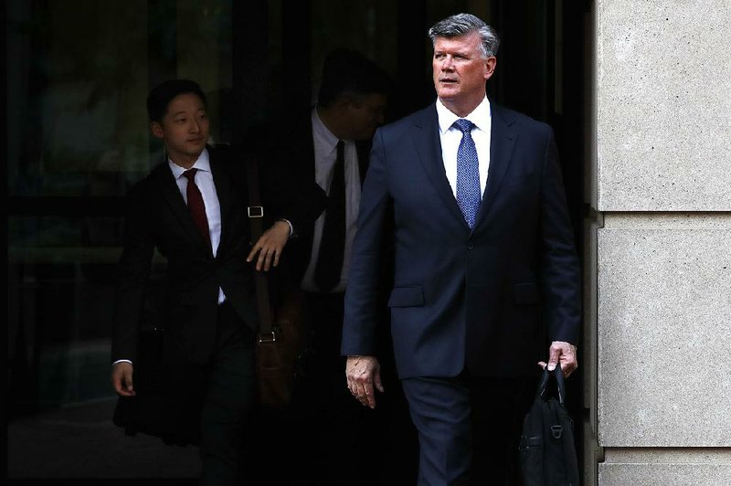 Kevin Downing (right), lead defense attorney for Paul Manafort, leaves federal court Tuesday in Alexandria, Va. Downing attacked the credibility of former Manafort associate Rick Gates and quizzed him about an extramarital affair.  