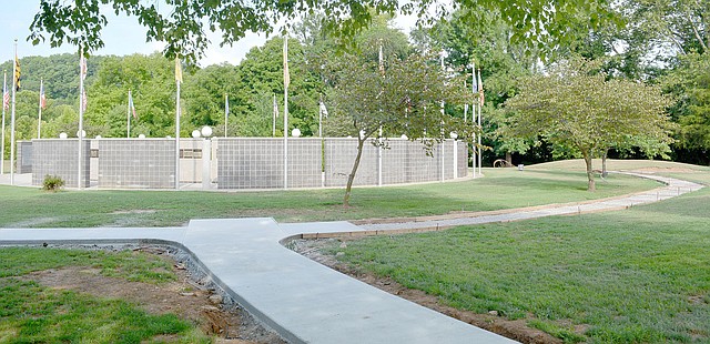 Keith Bryant/The Weekly Vista Concrete has started to appear for what will become a 1,000-foot, wheelchair accessible sidewalk next to the Veterans Wall of Honor. Outgoing veterans council president Gary Aaron said that the walkway, dubbed the Walk of Honor, will feature six benches. Funding for the project was provided by Lowe's, Cooper Communities and the POA.