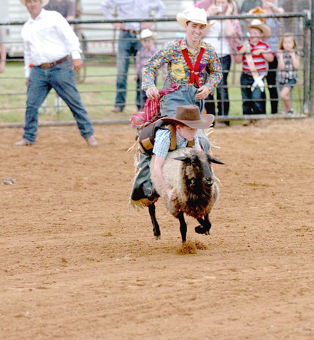 MARK HUMPHREY ENTERPRISE-LEADER In this 2017 photo, bull fighter Myles Essick, of Highlandville, Mo., doubling as a rodeo clown; gives chase as a young cowboy competes in Mutton Busting during the 64th annual Lincoln Rodeo. The 2018 Lincoln Rodeo is co-sanctioned by the ACRA and IPRA.