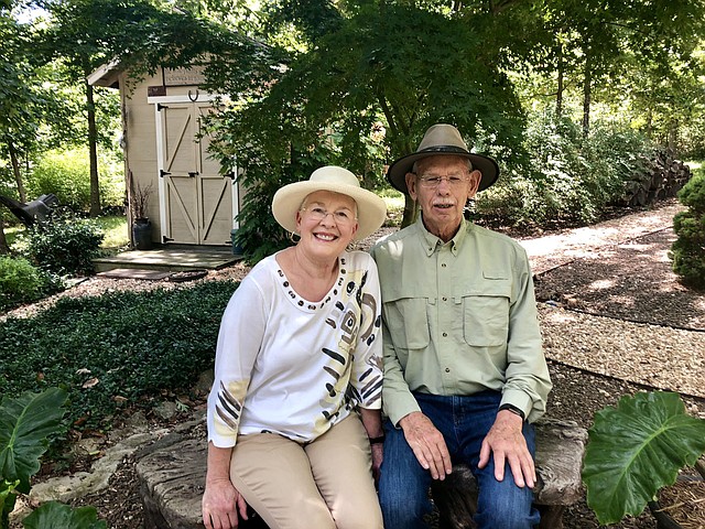 Photo submitted Ken and Bonnie Bloom take a seat in the outdoor sanctuary of their home at 4 Helensburgh Lane in Bella Vista. They are the homeowners chosen by BVGC as August Yard of the Month.