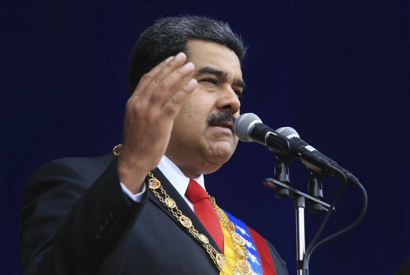 In this photo provided by the Miraflores Presidential Palace, President Nicolas Maduro speaks during a event marking the 81st anniversary of the National Guard, in Caracas, Venezuela, Saturday, August 4, 2018. Venezuela's government says several explosions heard at a military event were an attempted attack on President Maduro. Information Minister Jorge Rodriguez said in a live broadcast that several drone-like devices with explosives detonated near the president. He said Maduro is safe and unharmed but that seven people were injured. (Miraflores Presidential Palace via AP)