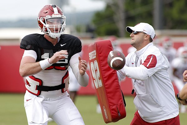 Arkansas offensive coordinator Joe Craddock, right, works with quarterback Cole Kelley during practice Wednesday, Aug. 8, 2018, in Fayetteville. 