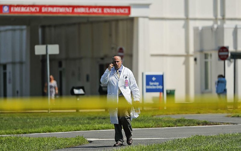 A physician leaves the emergency entrance Wednesday at Westchester Medical Center in Valhalla, N.Y., after a double shooting inside the hospital.  