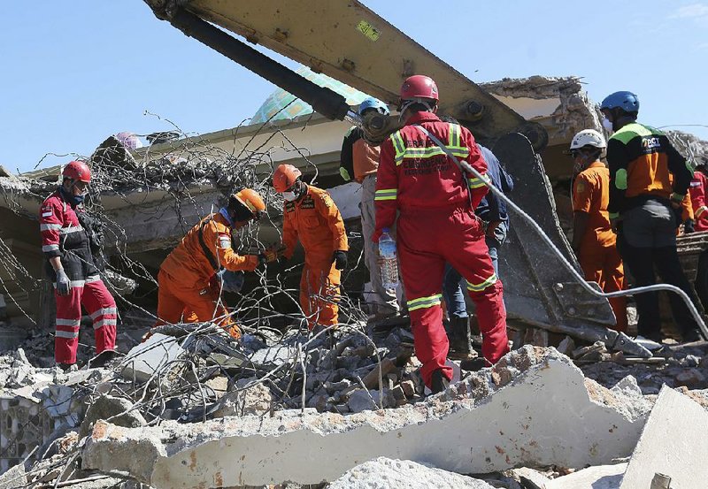 Rescue teams search for victims Wednesday in the collapsed Jamiul Jamaah Mosque in Bangsal, North Lombok, Indonesia.  