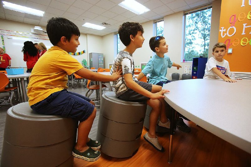 Students George Pitliangas (from left) and his brother, Stephanos, check out a classroom with Jax Strain and his brother, Colt, at the new Bobby G. Lester Elementary School in Jacksonville on Wednesday.  