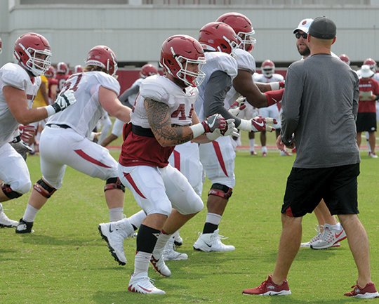 NWA Democrat-Gazette/David Gottschalk RAZORBACK SHUFFLE: Arkansas offensive lineman and tight end Austin Cantrell, front, run through drills Wednesday during the Razorbacks' practice on campus in Fayetteville.