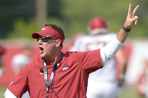 Arkansas coach Chad Morris directs his players Thursday, Aug. 9, 2018, during practice at the university's practice facility in Fayetteville.