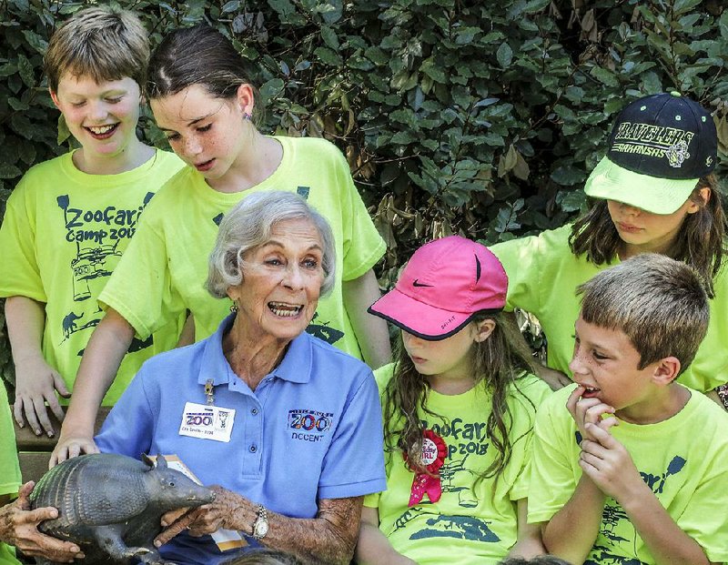 Em Smith, who has volunteered at the Little Rock Zoo since 1965, shows her preserved armadillo to children attending ZooFari Camp 2018.