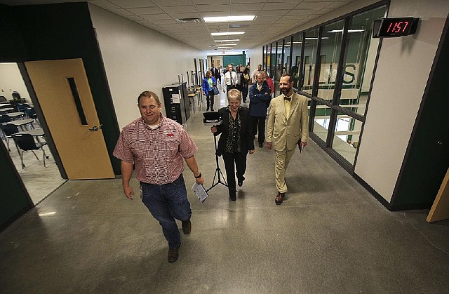 Scott Young with the Pulaski County Special School District leads U.S. District Judge D. Price Marshall Jr. (right), court reporter Christa Jacimore and others on a tour of the new Mills High School in this Thursday, Aug. 9, 2018 file photo. 