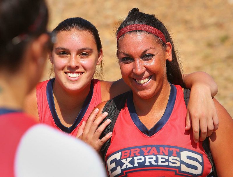 Marci Lewis, left, and her sister India Lewis, after their game at the Busch/Pepsi Softball Classic Saturday morning at the Sherwood Sports Complex.