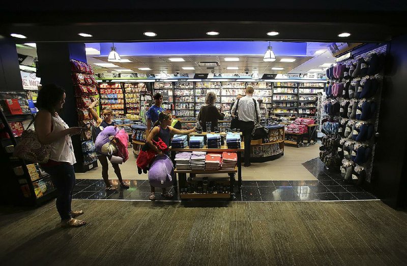 Passengers wait to check out at the newly opened Hudson News store near Gate 3 on Thursday at Bill and Hillary Clinton National Airport, Adams Field, in Little Rock.