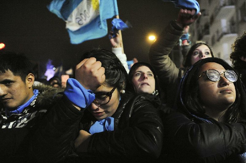 People opposed to decriminalizing abortion stand outside Congress in Buenos Aires, Argentina, as they wait early Thursday for news of the Senate’s vote on the issue.