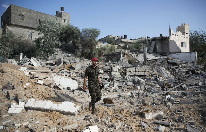 A Palestinian Hamas military policeman walks Thursday in the rubble of a site hit by Israeli airstrikes in Gaza City.