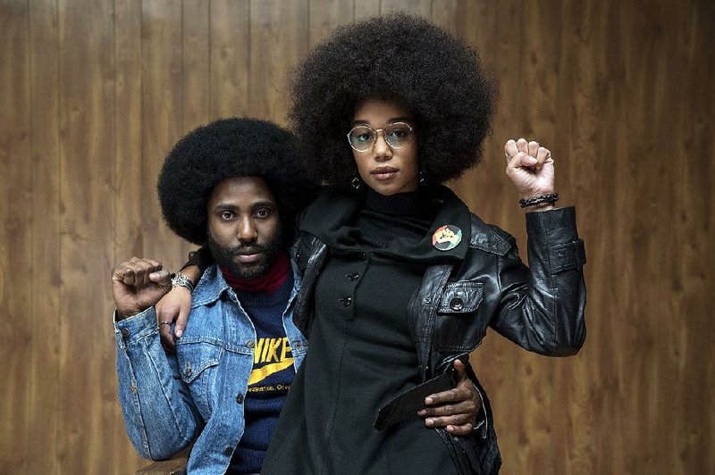 Rookie cop Ron Stallworth (John David Washington) walks a precarious line when he begins seeing Patrice (Laura Harrier) — the president of a college’s Black Student Union who has a certain skepticism about the police — in Spike Lee’s BlacKkKlansman.