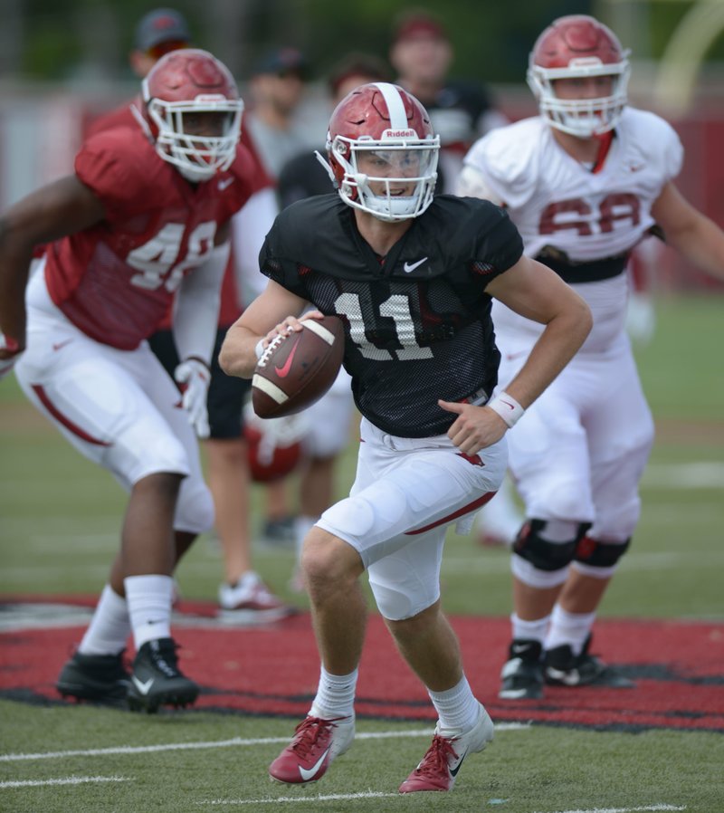 NWA Democrat-Gazette/Andy Shupe LOOKING FORWARD: Arkansas quarterback Daulton Hyatt rolls out to pass Thursday during practice at the university's practice facility in Fayetteville. Hyatt, along with Connor Noland and John Stephen Jones, took snaps with the Razorbacks first team in Thursday's practice.