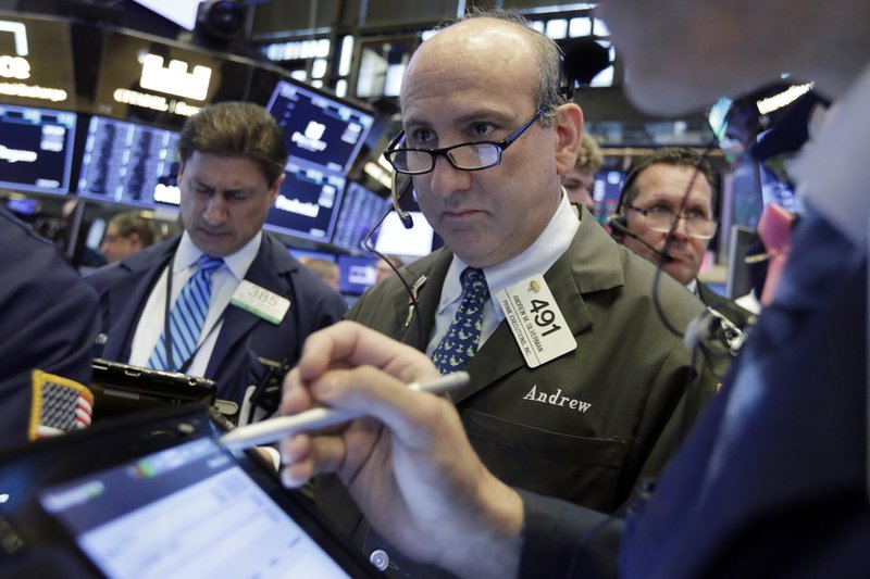 Trader Andrew Silverman, center, works on the floor of the New York Stock Exchange, Thursday, Aug. 9, 2018. Stocks are off to a mixed start on Wall Street as gains for technology companies are offset by losses elsewhere in the market. (AP Photo/Richard Drew)