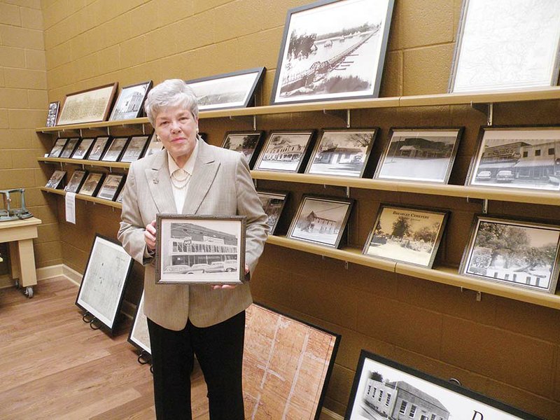 Mildred Diane Gleason collected many photos from days gone by in Dardanelle as she researched materials for her recent books. She holds one of her favorites — a photo f the Dardanelle Mercantile Co. that her family owned from 1882 to 1962.