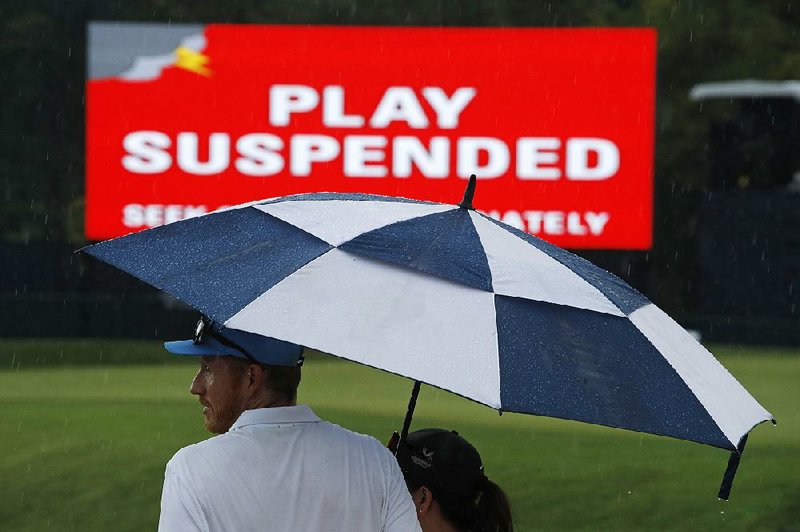 Rain and thunderstorms sent players and patrons scrambling for cover Friday afternoon during the second round of the PGA Championship at Bellerive Country Club in St. Louis. Play was suspended before 78 players could complete their round. 