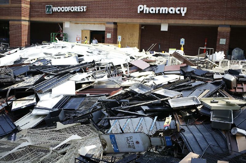 Debris sits outside a Kroger store in Spring, Texas, after Hurricane Harvey caused flooding there in September. The Federal Reserve used digital card-swipe data to compile a picture of economic damage last year from Harvey and Hurricane Irma.