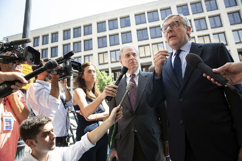 Paul Kamenar (right) and Peter Flaherty, attorneys for Andrew Miller, talk to reporters Friday at the district court in Washington after Miller was found in contempt for refusing to give testimony to a grand jury in special counsel Robert Mueller’s investigation into Russian interference in the 2016 election. 
