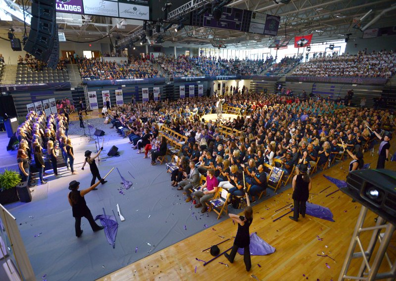 NWA Democrat-Gazette/ANDY SHUPE Teachers, administrators and staff of Fayetteville Public Schools watch Friday as students perform to open the Fayetteville Public Schools annual Convocation ceremony in Bulldog Arena on the Fayetteville High School campus. The event, which features performances by a combined choir and the high school band as well as awards and presentations, serves as a kickoff to the school year which begins Monday.