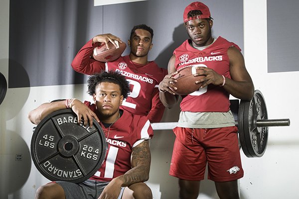 Arkansas running backs Devwah Whaley (21), Chase Hayden (2) and T.J. Hammonds (6) pose for a portrait during the Razorbacks' media day on Saturday, Aug. 4, 2018, in Fayetteville.