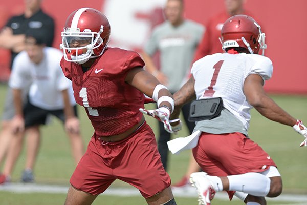 Arkansas defensive back Chevin Calloway (left) defends against receiver Jared Cornelius during a drill Tuesday, Aug. 7, 2018, during practice at the university practice fields in Fayetteville.