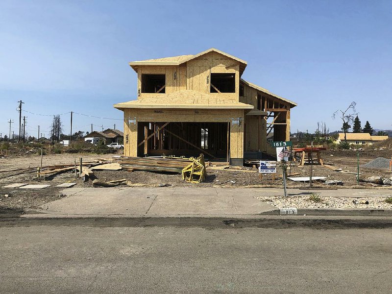 The partially rebuilt home of Debbie and Rick Serdin stands Friday in Santa Rosa, Calif. Debbie Serdin said she has seen construction prices rise for neighbors who waited to rebuild after a wildfire last year destroyed dozens of houses in their community.