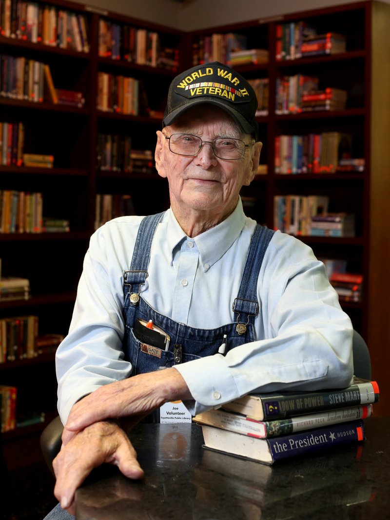 NWA Democrat-Gazette/DAVID GOTTSCHALK Joe Copeland, 98 and a volunteer with the Fayetteville Public Library for 40 years, sits Thursday, August 2, 2018, in the used book shop at the library.